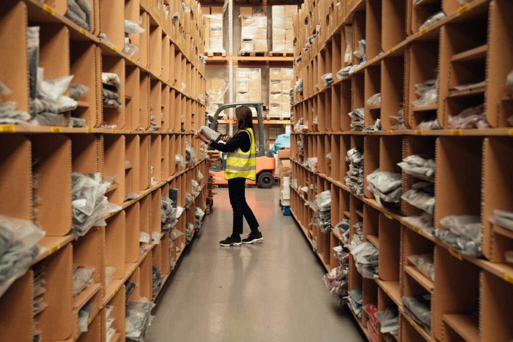 warehouse worker picking orders using a wms for ecommerce on a mobile device