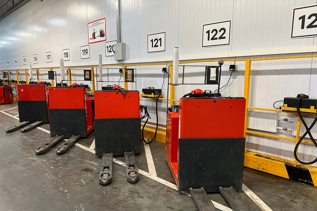 Electric forklifts charging in a warehouse
