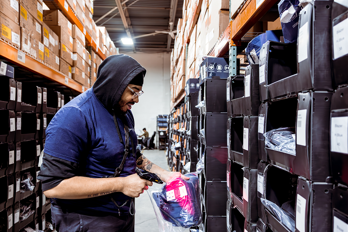 Worker uses barcode-based scanning in a fashion ecommerce warehouse